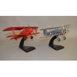 Two unboxed Bravo Delta aircraft models in 1:36 scale on stands, an Albatross in red 'D-2859' and