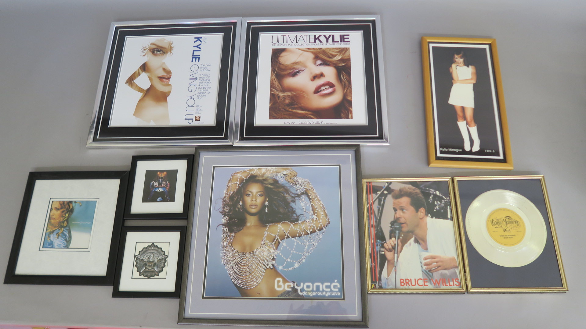 Closed record shop framed pictures including Ultimate Kylie CD DVD advert, Giving you up advertising