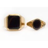 Two onyx set rings, one tested to 14ct approx 5.1gms, the other H/M 9ct approx 2gms