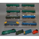 OO Gauge. 9 unboxed Tri-ang Locomotives, including green and yellow variants of the R155 Diesel