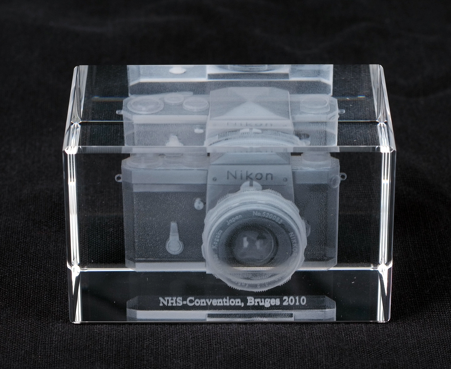 Small Perspex Paperweight Featuring a Nikon F.