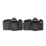 Pair of Black Nikon FM Camera Bodies.