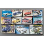 EX DEALER STOCK: 11x Model kits, mostly car related including AMT Ertl, Revell, Aoshima etc. all