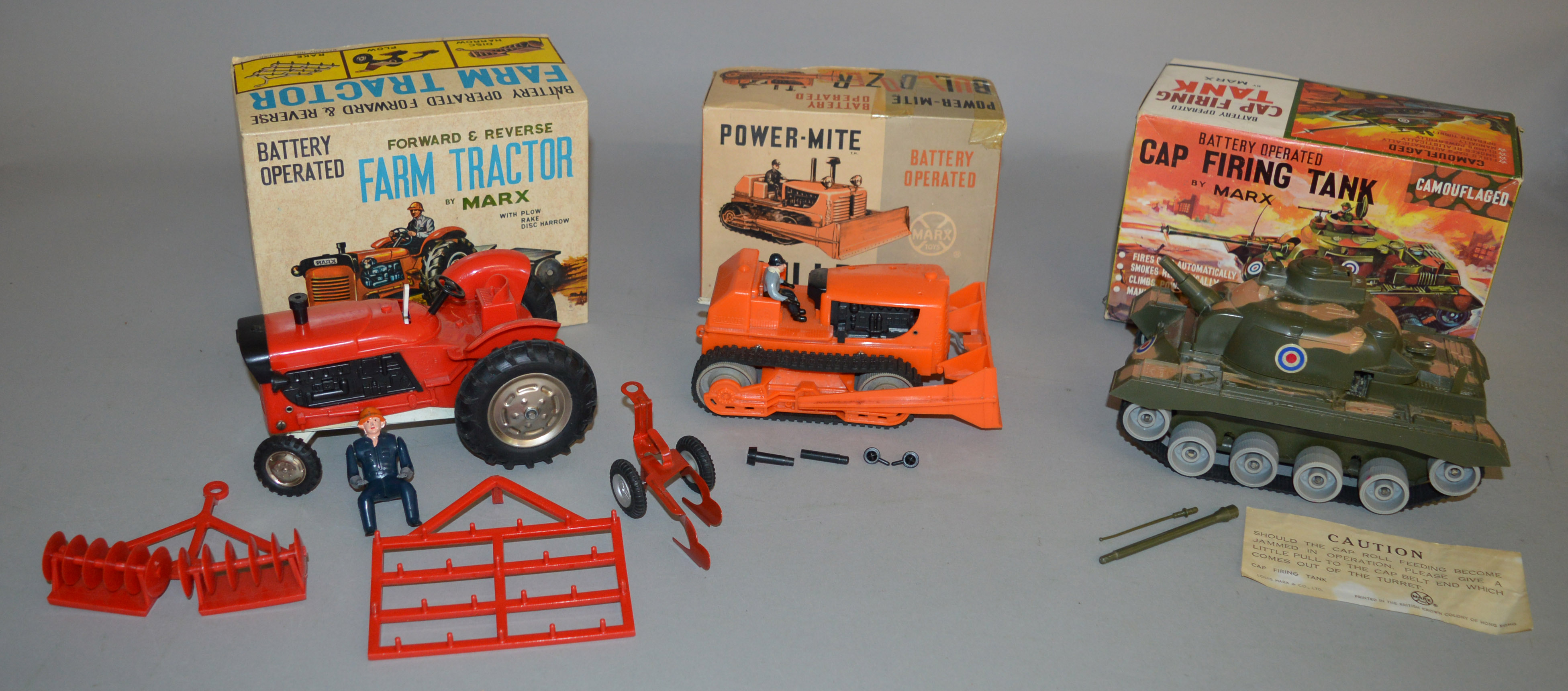 3x Battery operated Marx Toys including Power-Mite Bulldozer, Cap Firing Tank and Farm Tractor,