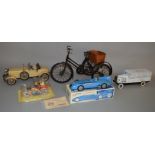 A model of a Tricycle together with four other tinplate vehicle models including a Schylling