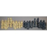 A modern resin chess piece set carved in a fantasy style