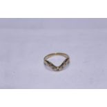 An 18ct H/M diamond set wishbone ring, the five round brilliant cut diamonds total approx 0.
