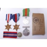 A WWII group of four medals to include 1939/45, F&G, Defence & War medals with slip & wound