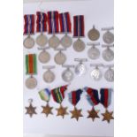 A quantity of WWII medals to include eleven War medals, six Defence medals, Atlantic Star, Pacific