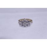 A diamond set cluster ring tested to 18ct, the nine round brilliant cut diamonds total approx 1.