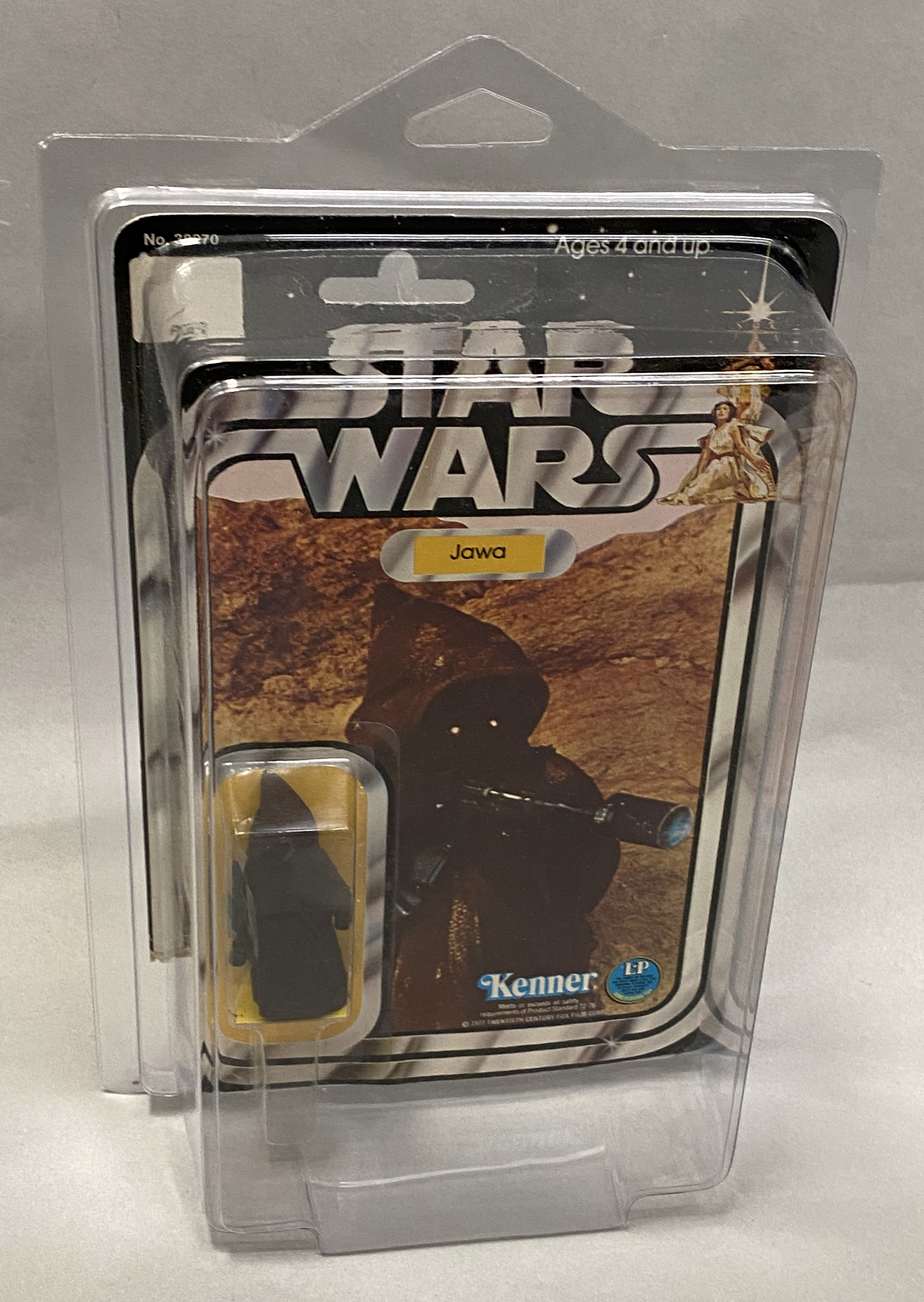 Kenner Star Wars Jawa on 12-back card. Note damage to card in photos. With protective perspex case.