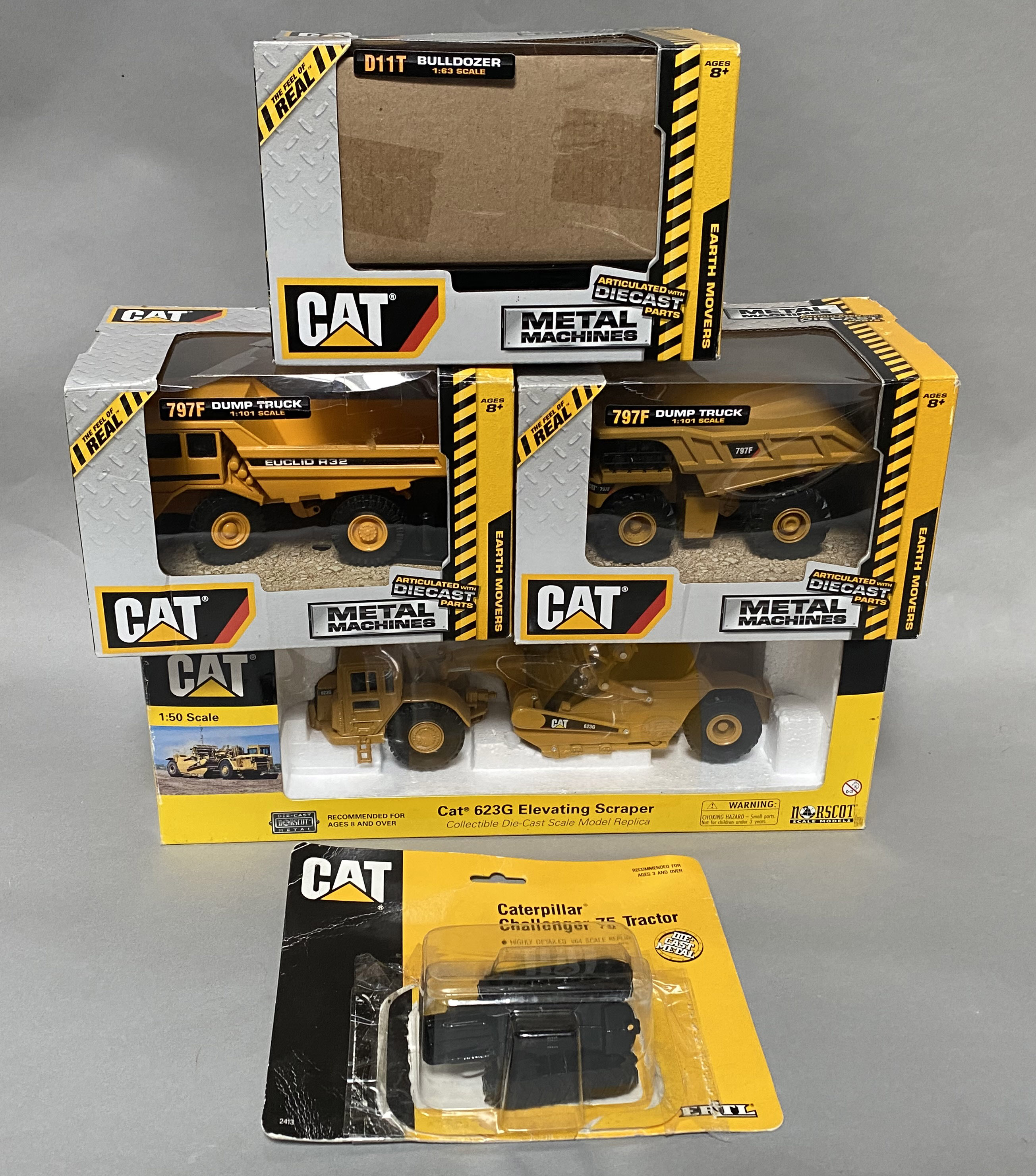 5x CAT construction vehicle models including examples by Norscott and Ertl, all boxed/carded.