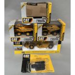 5x CAT construction vehicle models including examples by Norscott and Ertl, all boxed/carded.
