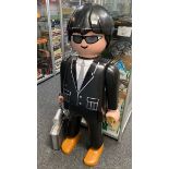 A large Playmobil life size shop display figure of a Security Guard with attached briefcase.