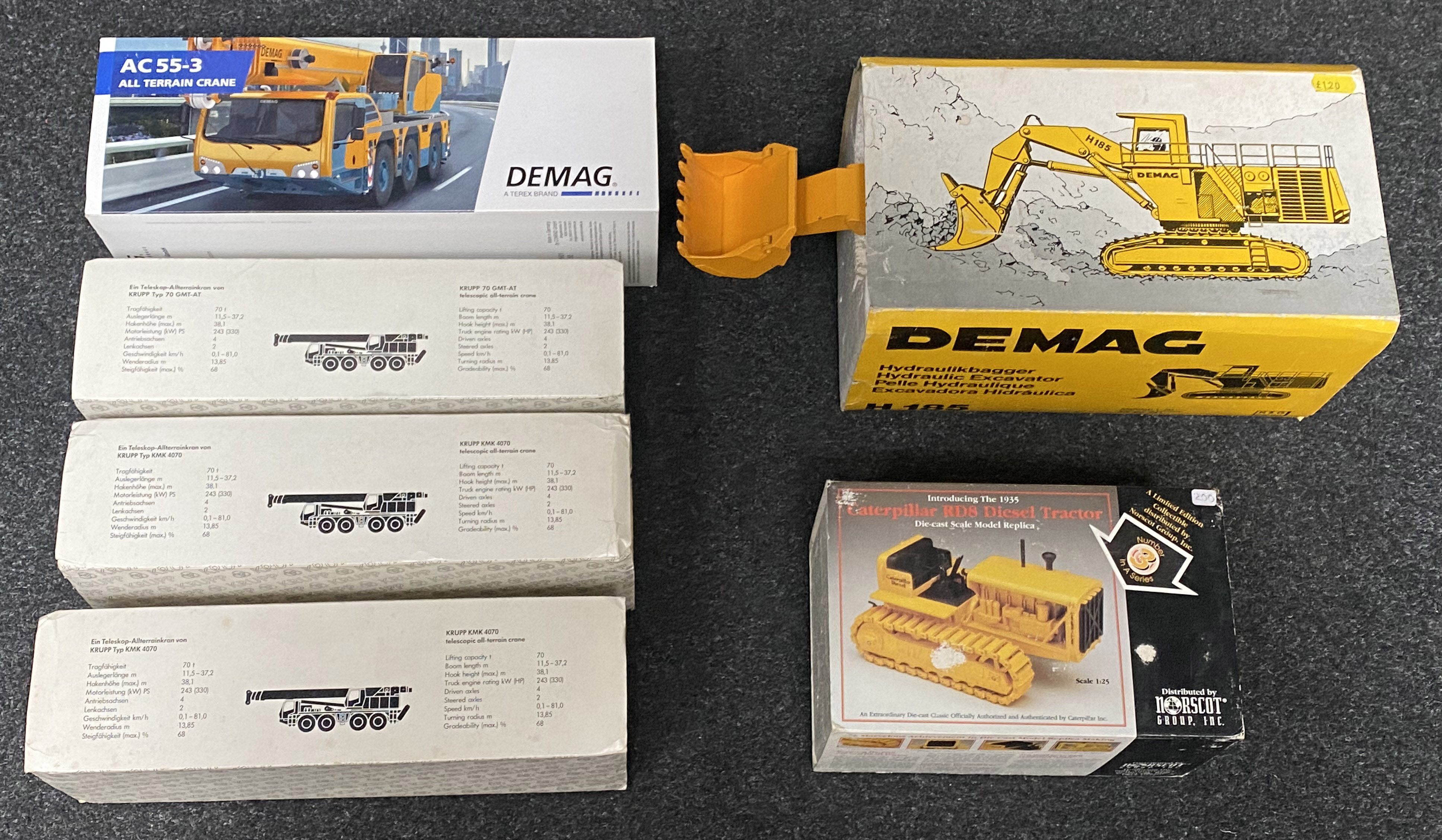 6x Construction vehicle models including Demag and Krupp examples, all boxed.