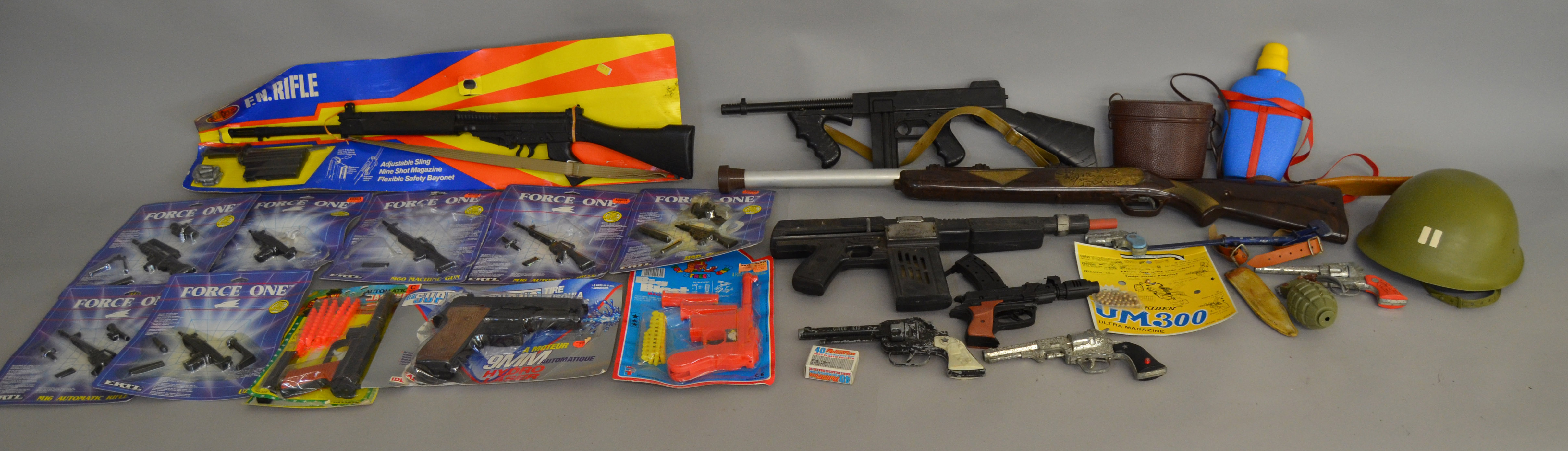 A mixed lot of toy weapons including an Airfix F.N. Rifle with card, Ertl Force One examples, etc.