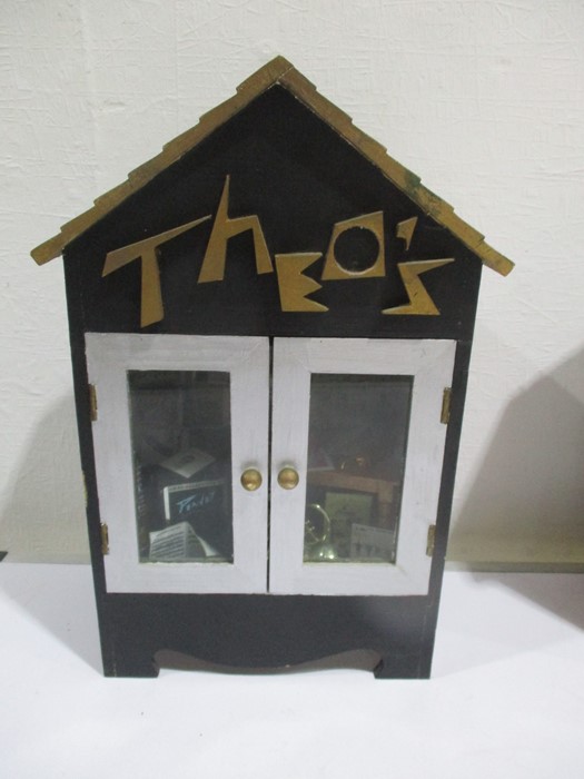 A diorama "Theo's" music shop with wooden building with musical instruments, records, sheet music