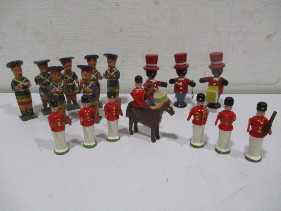 Two sets of wooden bandsmen along with wooden guardsmen