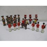 Two sets of wooden bandsmen along with wooden guardsmen