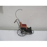 A metal dolls house carriage with leather button back seat