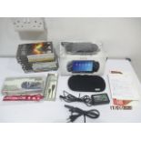 A boxed PSP console along with games and accessories