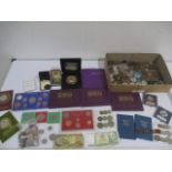 A collection of various coins including proof sets etc