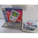 A boxed Nintendo Game Boy with four games