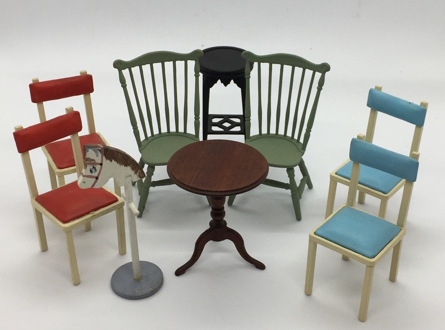 A small collection of miniature dolls house furniture, including chairs, torchere, tripod table