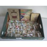 A collection of various cigarette cards