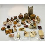 A collection of miniature dolls house food items, cake,hams, bread etc.