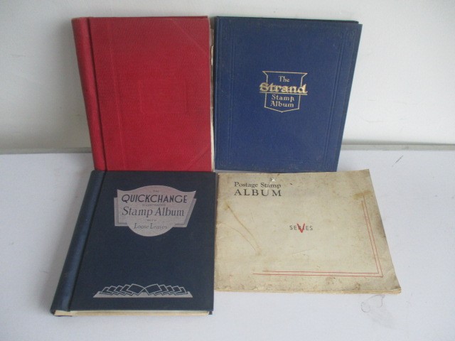 Two albums of various worldwide stamps along with an empty album