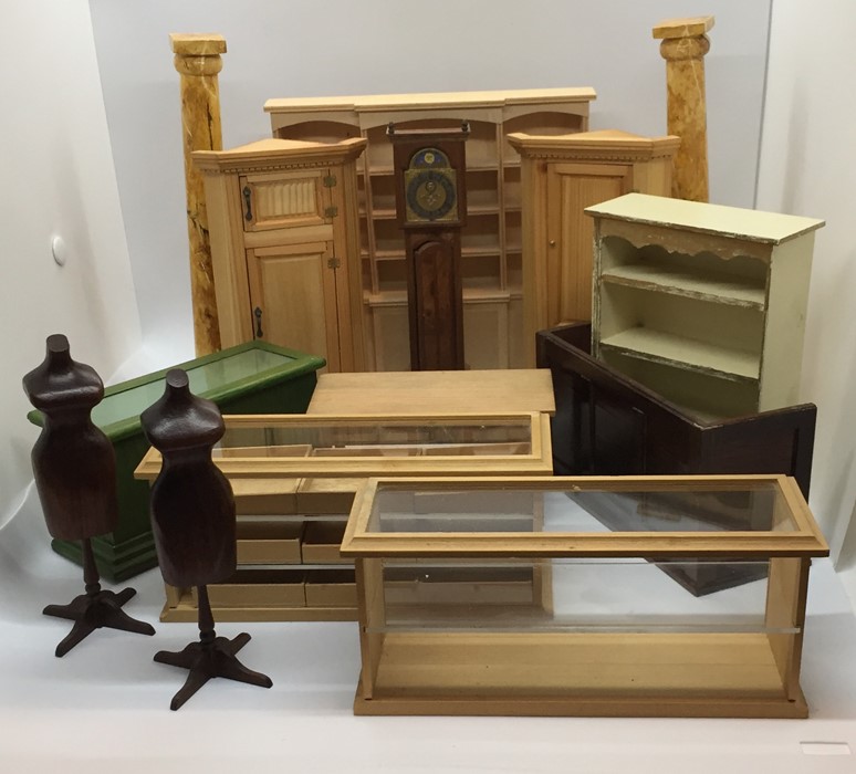 A collection of dolls house furniture including haberdashery cabinets, dress makers dummies, "