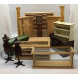 A collection of dolls house furniture including haberdashery cabinets, dress makers dummies, "