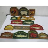 A collection of miniature wooden dolls house pub signs