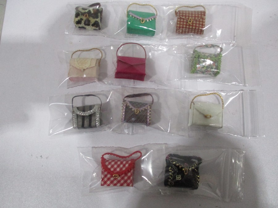 A collection of miniature dolls house ladies handbags