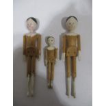 Three articulated "peg" dolls with painted faces