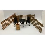 A miniature dolls house metal bistro set, wooden tea chest and picket fencing