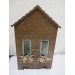 A diorama "Lucy's Antique Lace" with wooden building containing lace making and display, height 35