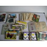 A collection of cigarette cards, postcards and cigarette packets