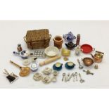 A collection of miniature dolls house items mainly kitchen related- tea sets, basket, cutlery etc.