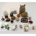 A collection of miniature dolls house food and similar items including potatoes, sprouts, cake etc.