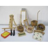 A collection of miniature dolls house kitchen items including wicker, ironing board, step ladder