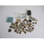 A collection of various coins and a £5 note