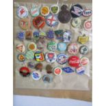 A collection of 43 vintage badges including motoring, Butlin's, Coca Cola etc.