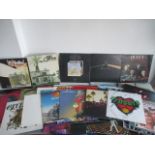 A collection of 12" albums and singles including Led Zeppelin, Pink Floyd, Queen, John Lennon, Elton