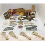 A collection of miniature dolls house items, advertising, leopard skin rug, plate rack, shop display