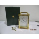 A brass carriage clock in box with key, marked DP