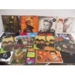 A collection of records including The Beatles, Queen, David Bowie, Elvis Presley, Jimi Hendrix etc