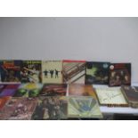 A collection of records including The Beatles, The Who, Rod Stewart, Queen, Jimi Hendrix,