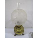 A brass oil lamp and shade